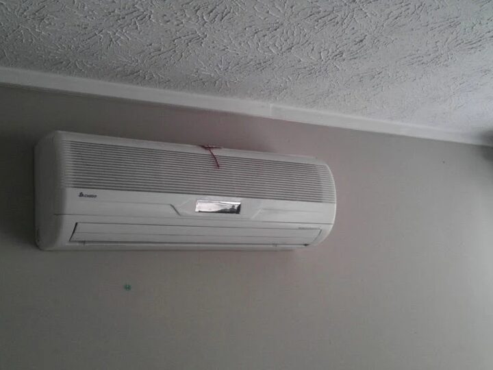 Ductless mini-split outdoor units mounted at a building