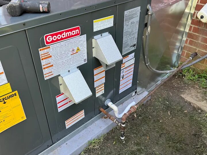 A technician servicing the coil section of an air conditioning unit