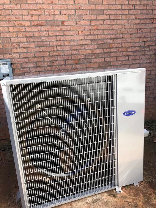 Carrier condenser installed against the house